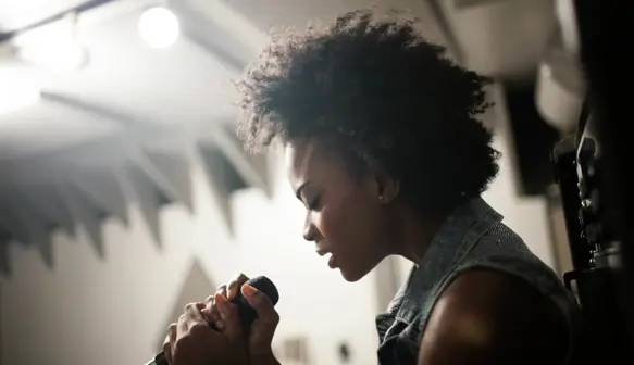 Close up of a woman singing into a microphone