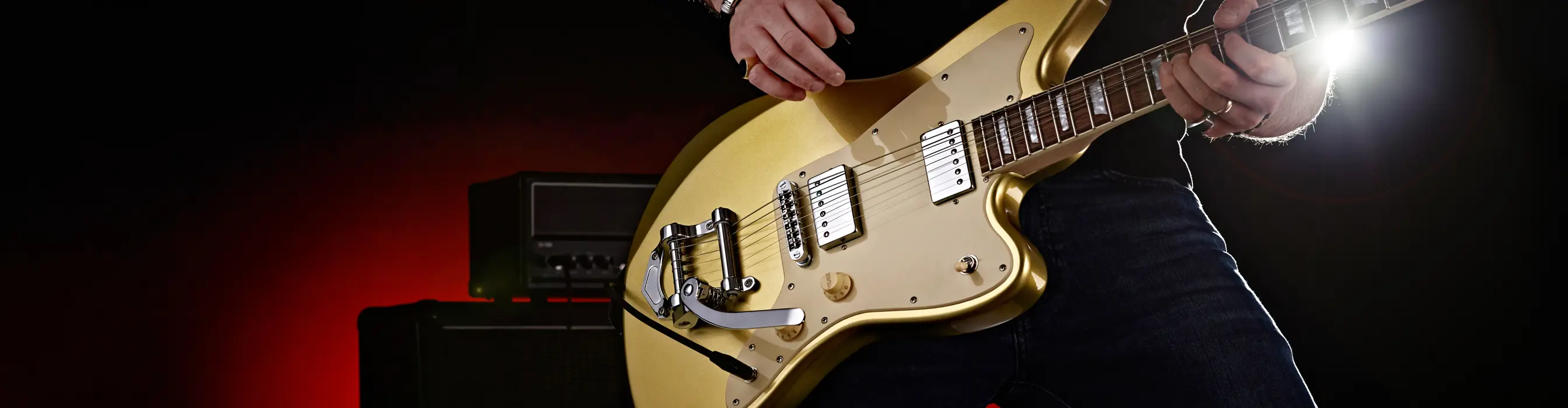 Close up product shot of a guitar being played by a man