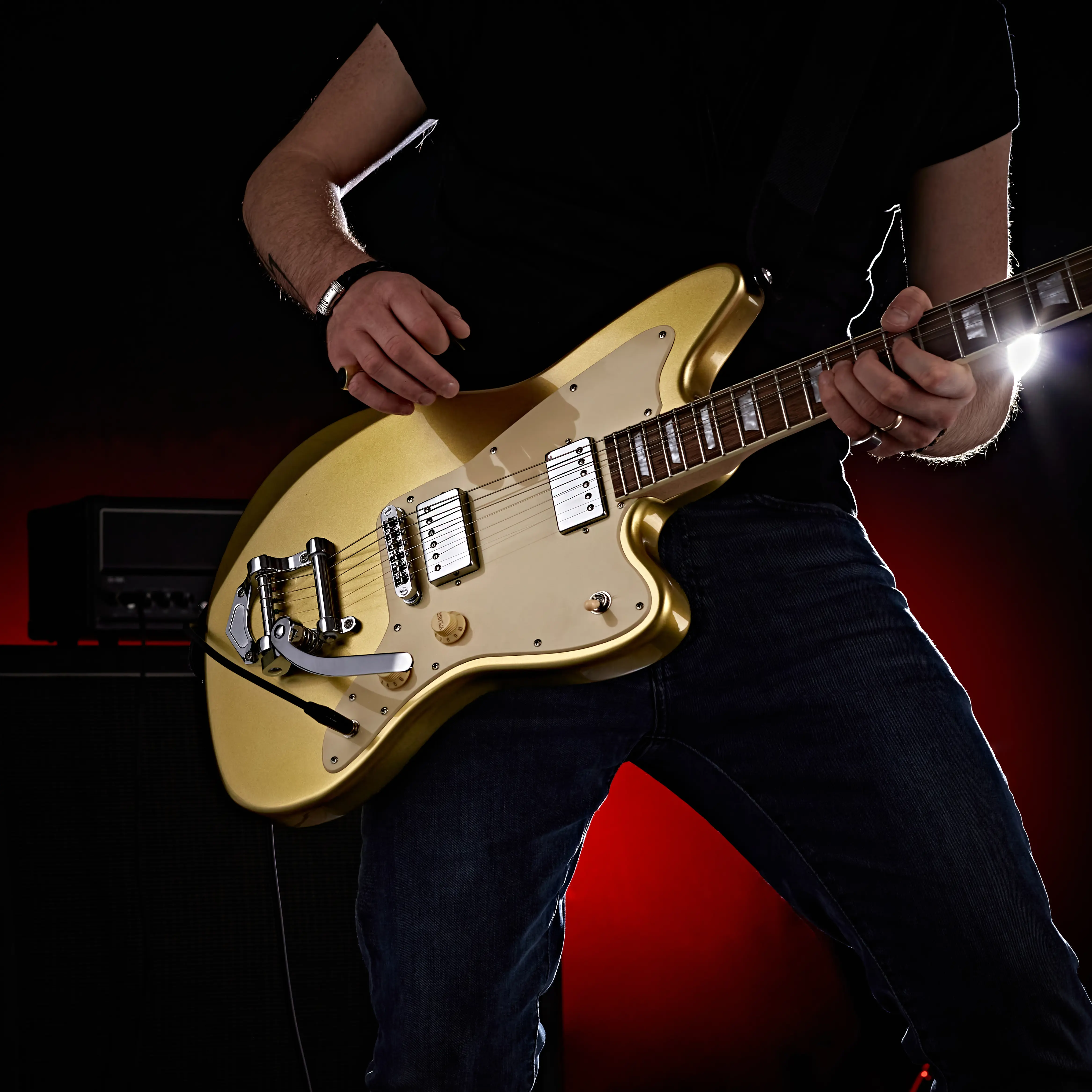 Close up product shot of a guitar being played by a man