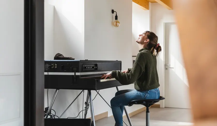 A girl playing a large electric keyboard